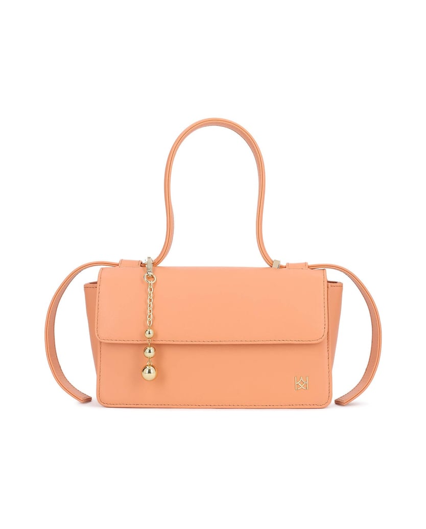 Kazar-Orange-oblong-bag-with-decorative-strap-and-keychains-oranžová